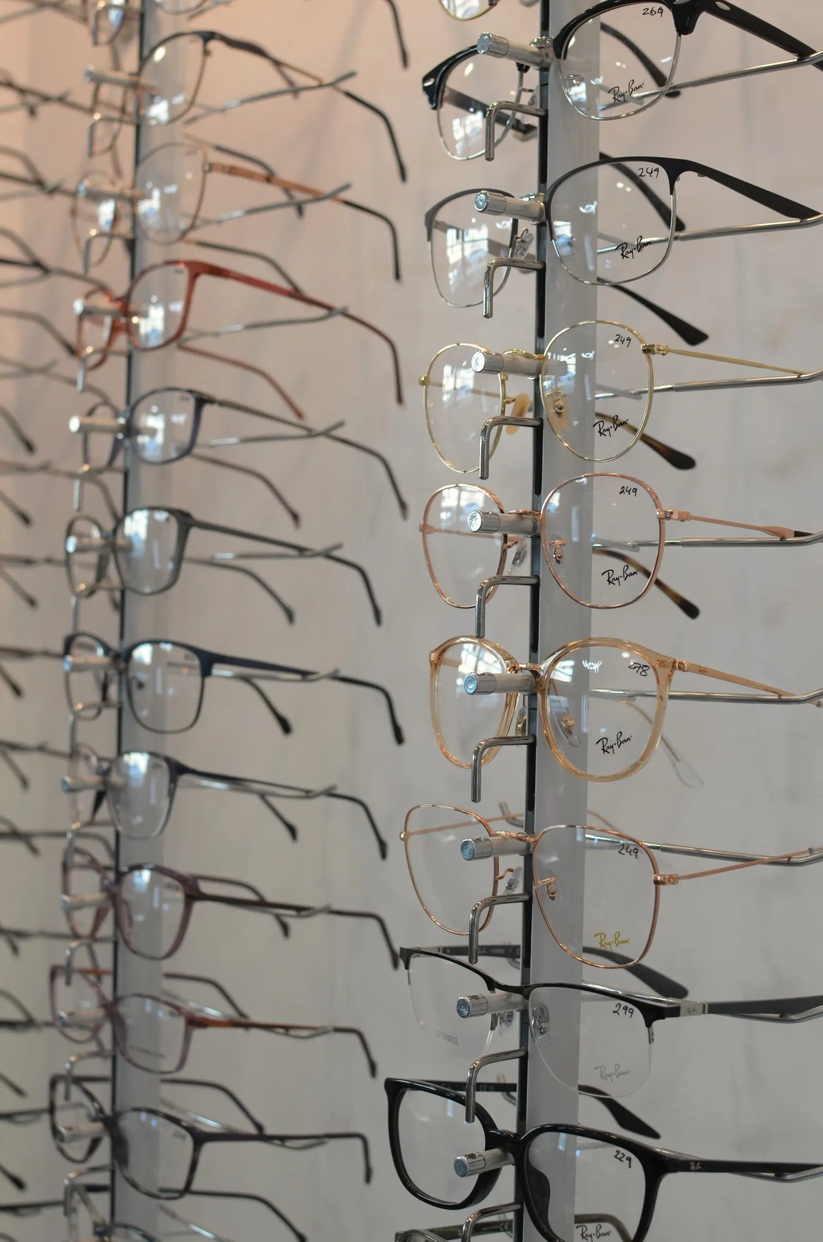 Rows of eyeglass frames on display rods